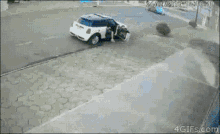 a blue car is parked on the side of the road next to a mini cooper