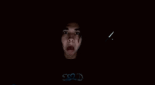 a person 's face is visible in the dark with the word ssr2d written on the bottom