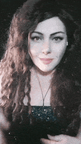 a woman with long curly hair wearing headphones