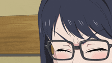 a close up of a person wearing glasses with their eyes closed and a red spot on their forehead