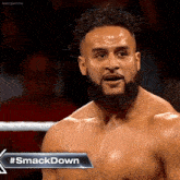 a man in a wrestling ring with the hashtag #smackdown on the bottom right