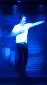 a man in a white shirt is standing on a stage with the words a face without behind him