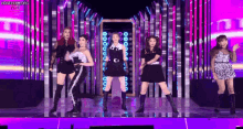 a group of young women are standing on a stage .