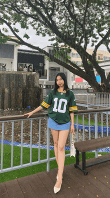 a girl wearing a green jersey with the number 10