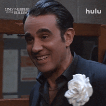 a man with a white flower in his lapel is smiling in a hulu ad
