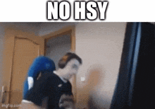 a man is sitting in front of a computer with the words no hsy written on the bottom