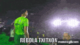 a man in a green shirt stands in front of a crowd with the words rebola txitxon on the bottom