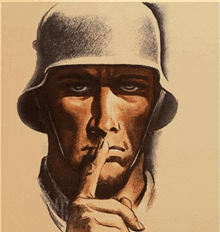 a man in a helmet is holding his finger to his mouth
