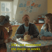 three women are sitting at a table with the words she 's not mentioned the doctor in weeks below them