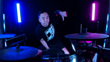 a man playing drums with a shirt that says ' ec ' on it