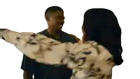 a man and a woman are hugging each other and the woman is wearing a shirt with the letter g on it
