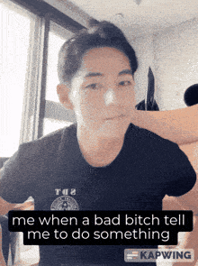 a man in a black shirt with the words me when a bad bitch tell me to do something