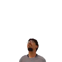 a man with glasses looks up at a green cross on his head