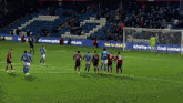 a group of soccer players standing on a field with a sign that says new for 2024