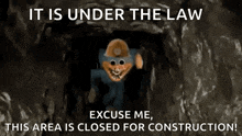 a cartoon character is standing in a cave with a sign that says `` it is under the law '' .