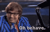 a man in a blue striped suit and tie is sitting in a car and says oh behave .