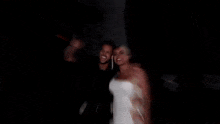 a man is kissing a woman on the cheek in the dark