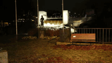 a statue of a man standing in front of a waterfall with a sign that says ' a ' on it