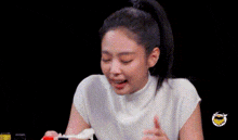 a woman is eating food with a spoon from a bowl .
