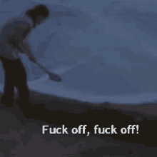 a blurred image of a person holding a shovel with the words fuck off fuck off