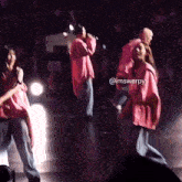 a group of people are dancing on a stage with the name imswerpy written on the bottom