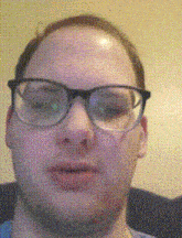 a man wearing glasses is looking at the camera with a yellow background