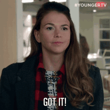 a woman in a plaid shirt says got it on her face