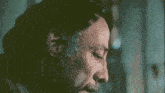 a close up of a man 's face with a man in the background