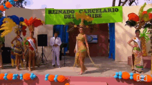 a group of women are dancing in front of a banner that says reinado carcelario del ribe