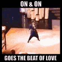 a woman is dancing on a stage with the words " on & on goes the beat of love " above her
