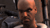 a bald man with a beard is looking at something