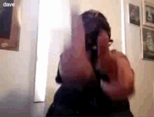 a man is pointing a gun at the camera with the name dave visible in the corner