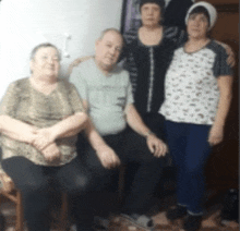 a group of people posing for a picture including two women