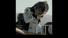 a man wearing a helmet and a shirt with the number 9 on it