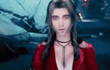 a woman with long hair and a red jacket is standing in front of a broken car .