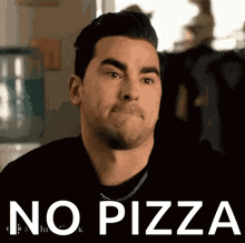 a man is making a funny face with the words no pizza behind him