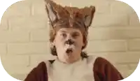 a man in a fox costume making a surprised face