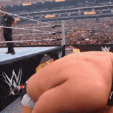 a man in a wrestling ring with the letter w on the side