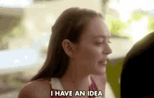 a woman is saying i have an idea in a blurry photo