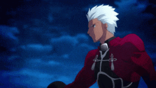 a man with white hair is wearing a red jacket with a bow on it