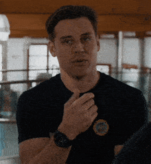 a man wearing a black shirt with a fire department patch