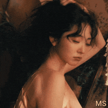 a close up of a woman 's face with the letters ms on the bottom right