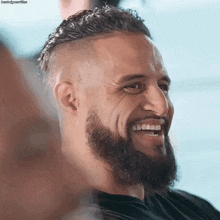 a man with a beard and a black shirt is smiling for the camera with the hashtag bootlegjustfine at the bottom