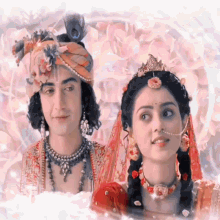 a man and a woman are standing next to each other and the woman is wearing a tiara