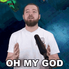 a man with a beard is speaking into a microphone and says oh my god