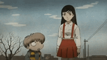 a girl in a red skirt stands next to a boy