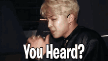 a close up of a person 's face with the words `` you heard ? ''