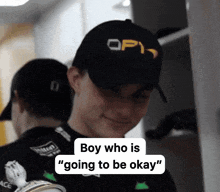 a man wearing a hat that says op1 on it says " boy who is going to be okay "