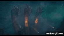a man is standing in front of a group of dragons with long necks .