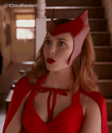 a woman in a red costume is standing in front of a set of stairs .